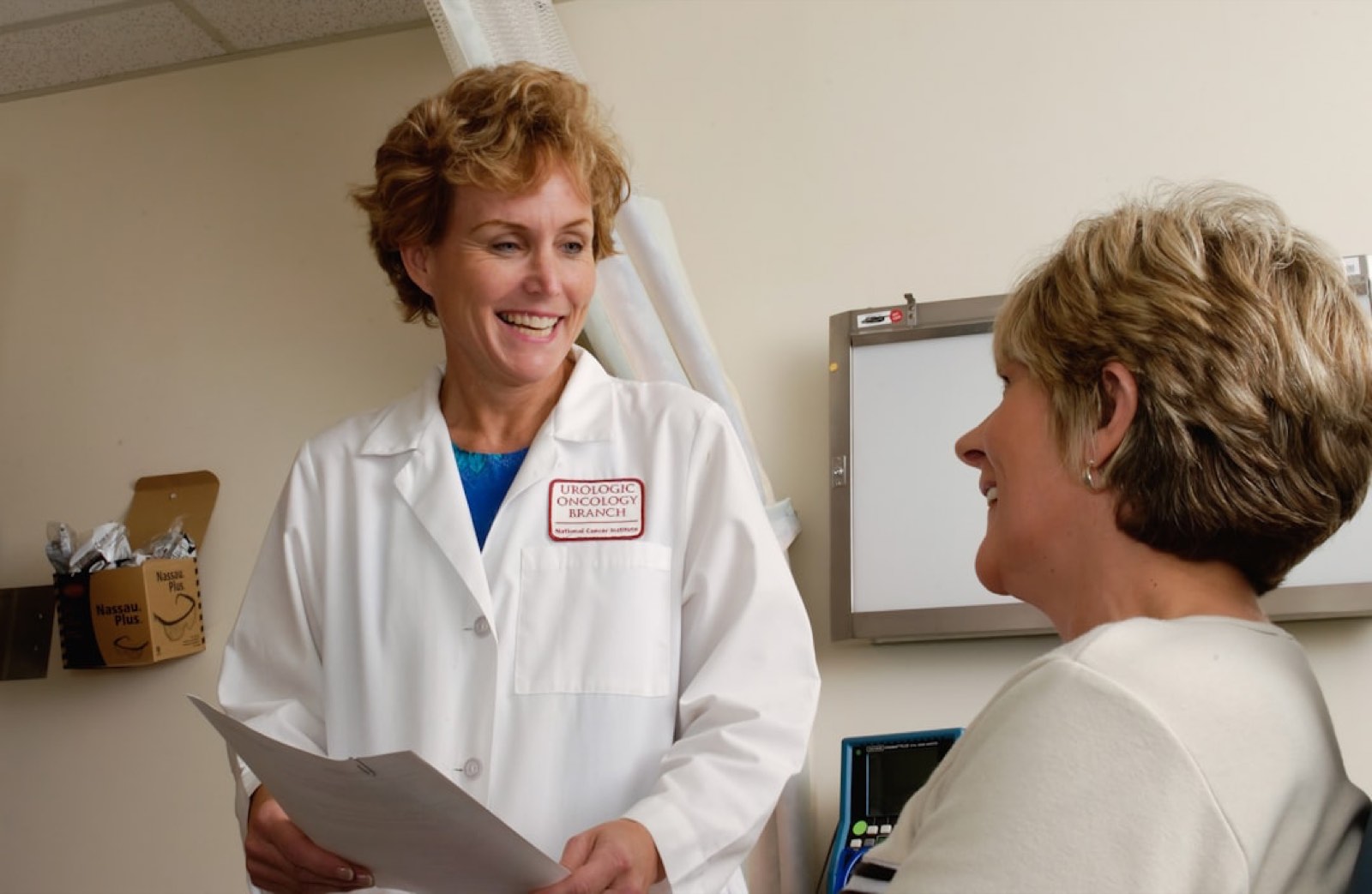A clinician in conversation with a patient during a consultation